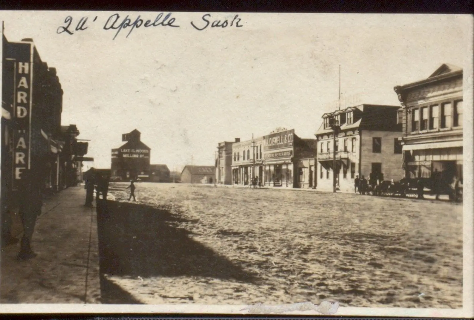 Main Street with storefronts and grain elevator